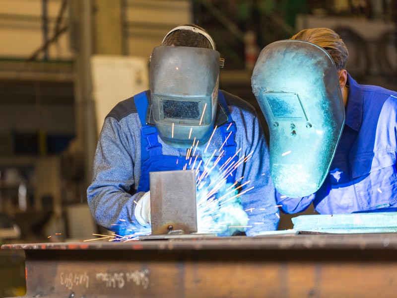 Two men welding